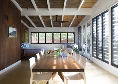 Living and dining area with walls of breezway louvres